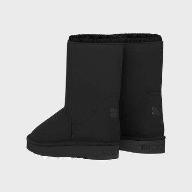 Pair of black vegan boots on a light gray background