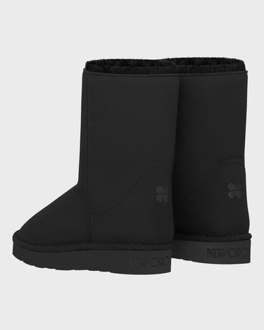 Pair of black vegan boots on a light gray background