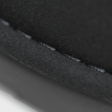 Close-up of boot black fabric with a visible seam on a white background