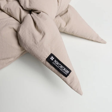 Light beige vegan capuche made from recycled materials with a soft, textured fabric and pointed ends. - The New Orchard CH