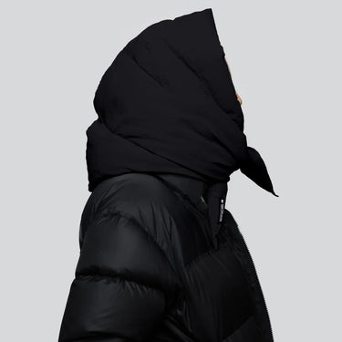 Black vegan puffer jacket with large hood, made from recycled materials, side view. - The New Orchard CH