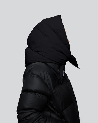 Black vegan puffer jacket with large hood, made from recycled materials, side view. - The New Orchard CH