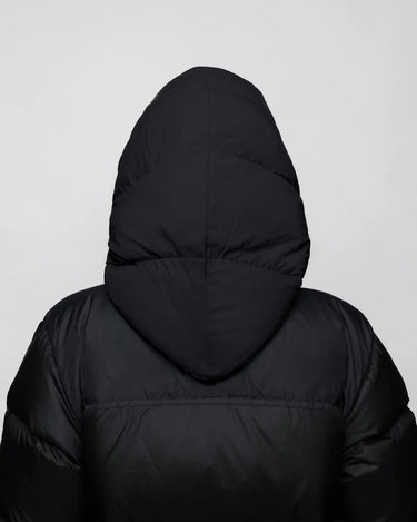 Black vegan puffer jacket with hood made from recycled materials, shown from back. - The New Orchard CH