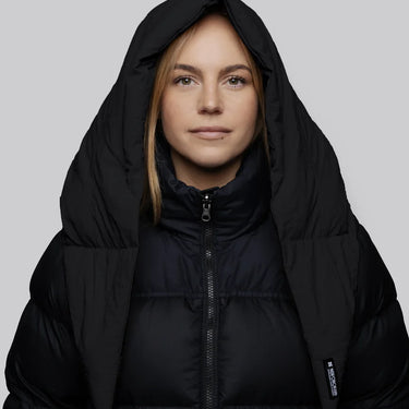 Black vegan puffer jacket with hood made from recycled materials, sleek charcoal tone. - The New Orchard CH