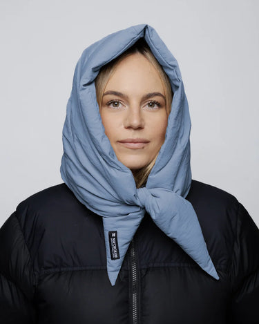 Sky blue vegan winter capuche made from recycled materials worn with black puffer jacket. - The New Orchard CH