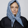 Sky blue vegan winter capuche made from recycled materials worn with black puffer jacket. - The New Orchard CH