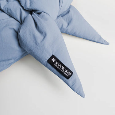 Sky blue winter capuche made from vegan, recycled materials with brand label detail. - The New Orchard CH