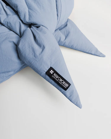 Sky blue winter capuche made from vegan, recycled materials with brand label detail. - The New Orchard CH