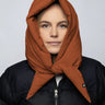 Vegan cinnamon-colored capuche made from recycled materials worn over black puffer jacket. - The New Orchard CH