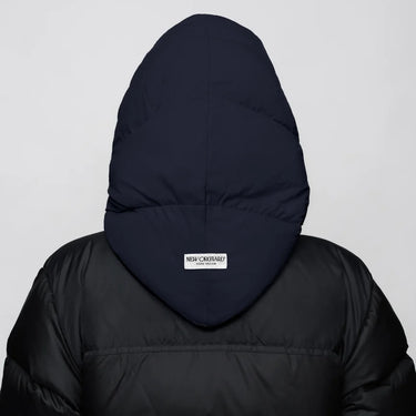 Navy blue vegan winter capuche made from recycled materials on black puffer jacket back view. - The New Orchard CH