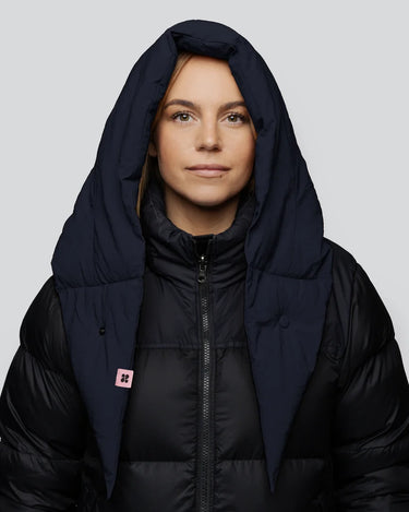 Navy vegan puffer capuche hood made from recycled materials with a large, padded design. - The New Orchard CH