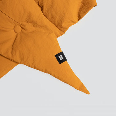 Amber yellow vegan winter capuche made from recycled materials with button detail and black logo tag. - The New Orchard CH